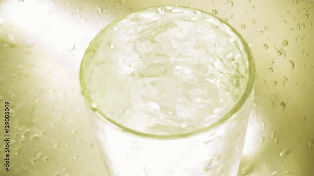 Clean water is poured into the glass in slow motion 480 fps blurry Clean water is poured into the glass in slow motion 480 fps blurry
