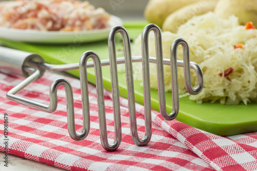 Canvas Print Potato masher and ingredients for typical dutch dish zuurkool