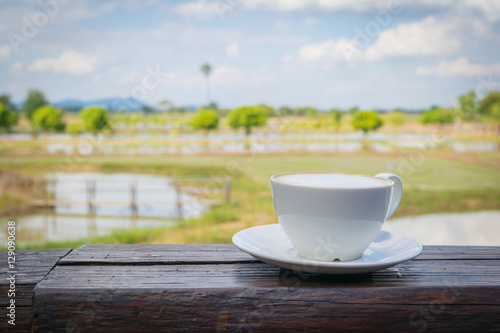 Close up white cup of Coffee, latte on the wooden table