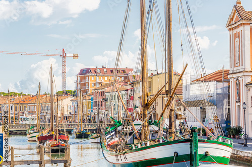 Fotografie Antique fishing boats in harbor channel