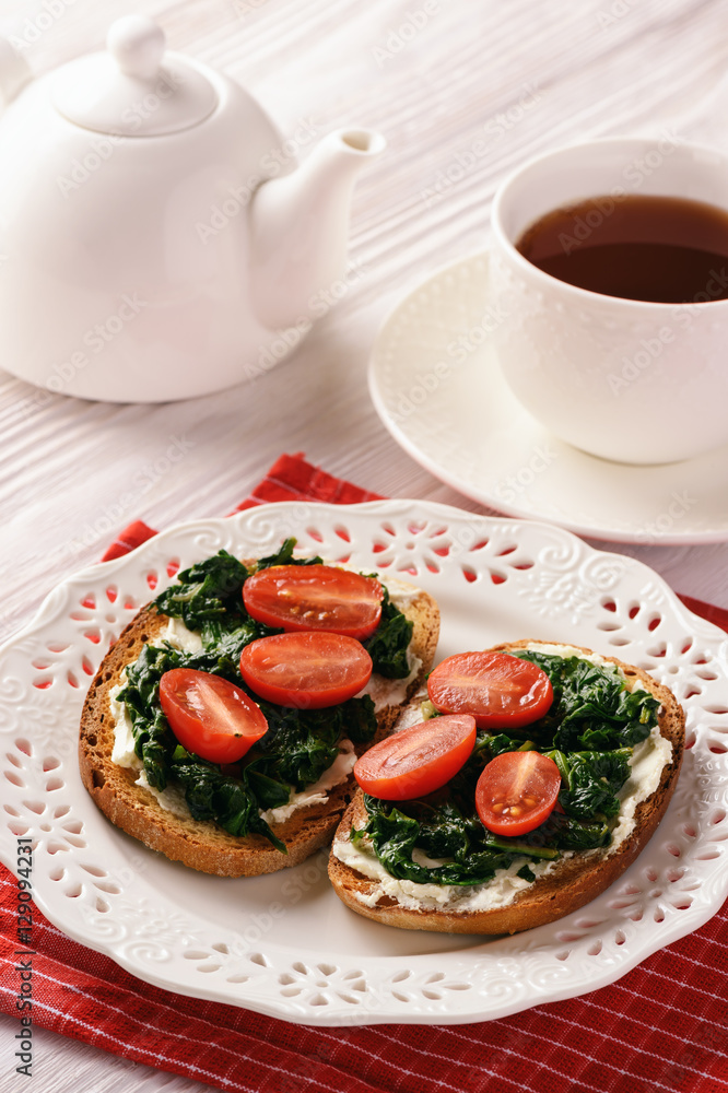 Toasts with spinach, cream cheese and tomatoes. Toasts with spinach, cream cheese and tomatoes.