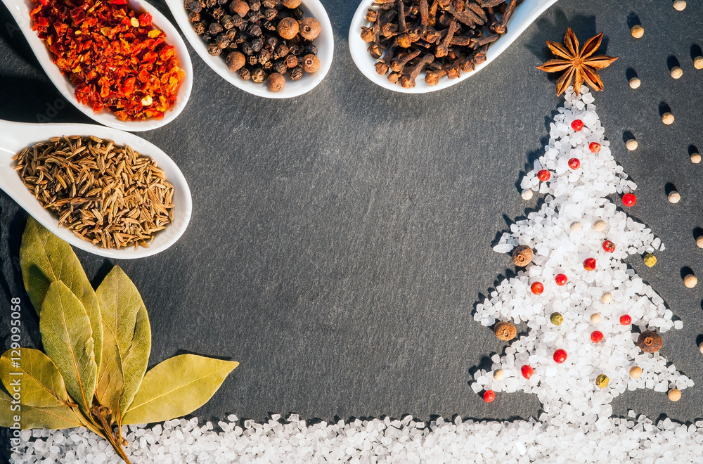 Fototapeta premium Paprika, cummin, star anise, cloves, allspice ,Bay leaf, black, white and red pepper and salt spices. Background of spices. Christmas background of spices.