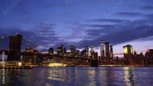 View of Brooklyn Bridge with the distinctive New York skyline in background at sunset, New York , United States