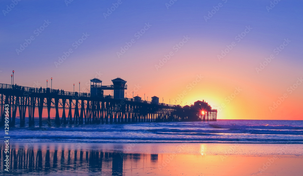 Vintage beach photo of pier at sunset in California 