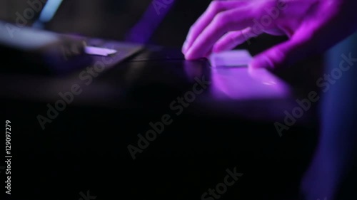 hands of musician playing keyboard in concert