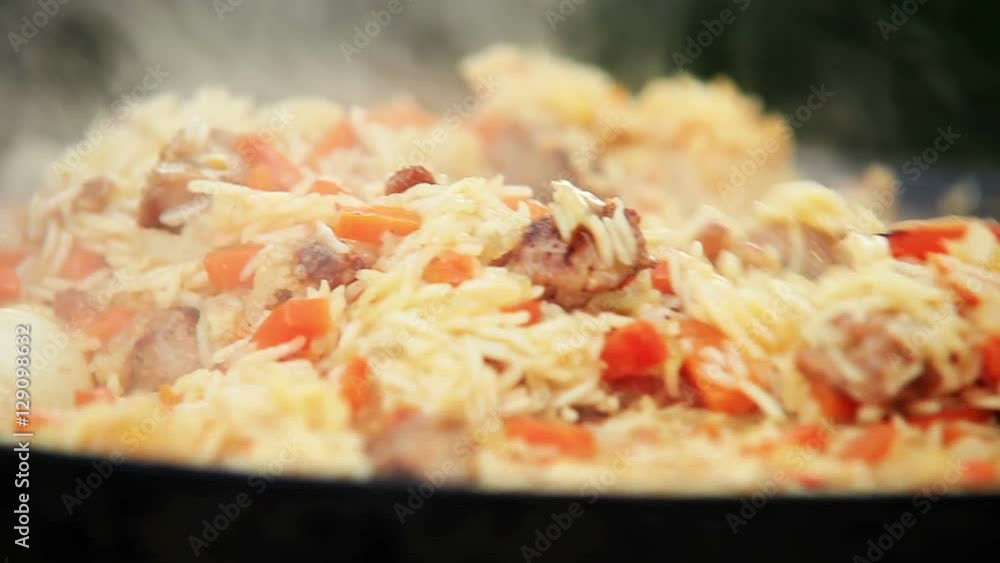 Traditional Uzbek (Middle Asia) dish is mixed during the preparation Traditional Uzbek (Middle Asia) dish is mixed during the preparation