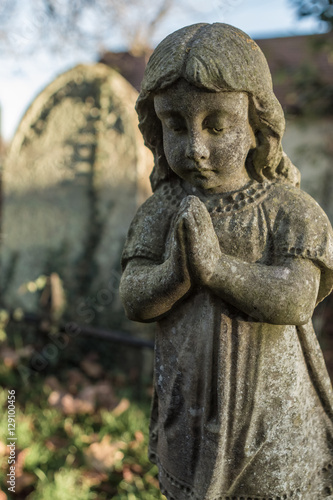 Statue of praying  child in graveyard