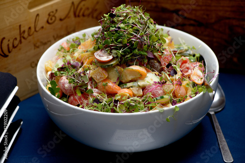 Salad in a Bowl with Tomato, Cuccumber and Clover photo