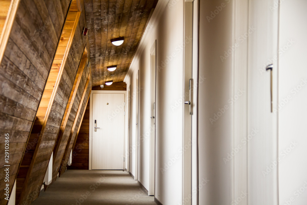 Perspective of a corridor with wooden walls in a hotel or dorm Perspective of a corridor with wooden walls in a hotel or dorm