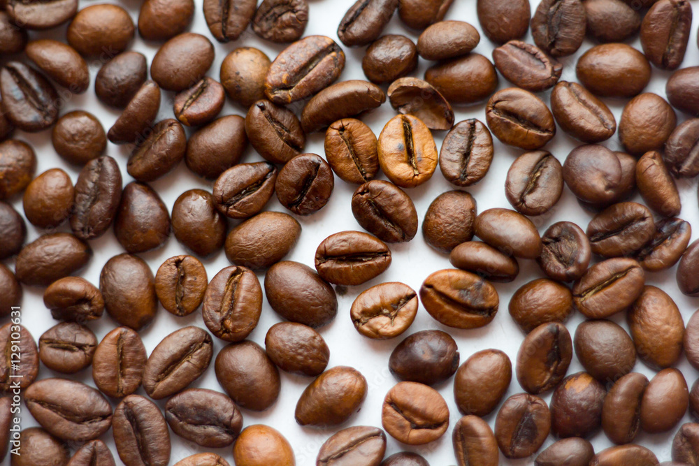 Close up beans on a white background. Coffee the entire screen for the . Roasted brown. Lots of in high definition. Close up beans on a white background. Coffee the entire screen for the . Roasted brown. Lots of in high definition.