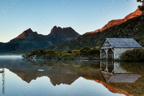 Early morning light illuminates mountain peaks reflecting in the