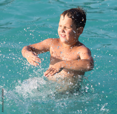 boy swims with a splash in the water park © schankz