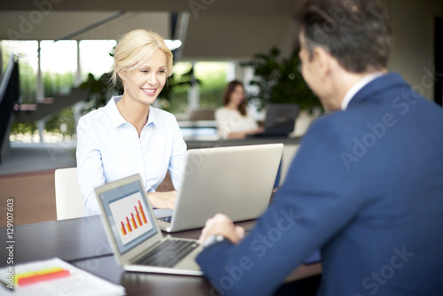 Wallpaper Mural Business people at work. Portrait of two happy colleagues using a laptops in the office while working on business presentation. Torontodigital.ca