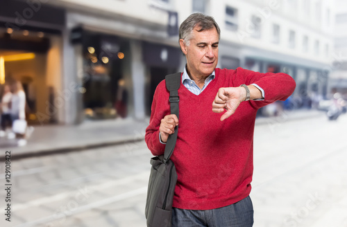 Senior man watching his wrist watch photo