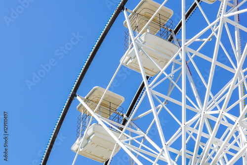 Underside view of a ferris wheel rotating downward