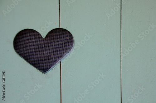 Blue wooden door with a heart in the middle
