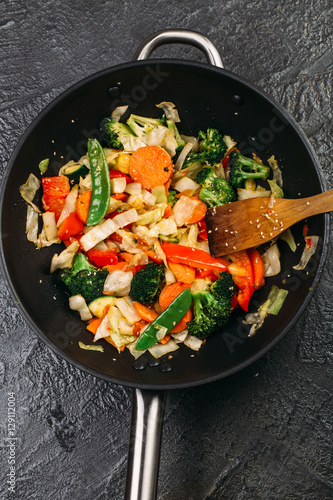 Tasty vegetable dish with broccoli and colorful peppers cooked in oil stained asian wok recipe 