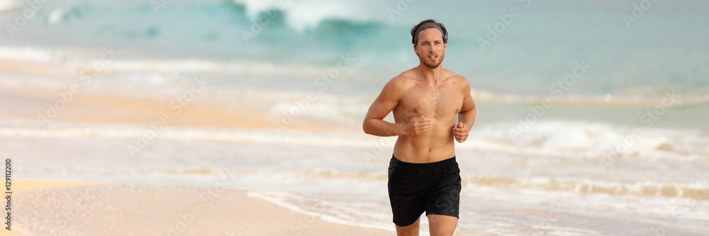 Man athlete running topless in shorts on beach at sunset. Male fitness runner training cardio alone. Banner of ocean background. Healthy active lifestyle. Panorama horizontal copyspace.