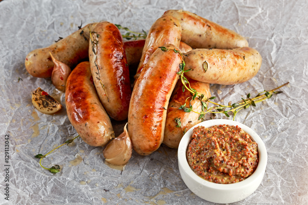 Home-made Pork Sausages on crumpled paper with thyme
