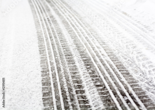 Wheel tracks on the road covered with snow