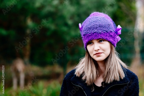 Thoughtful young woman in woolen violet blue cap