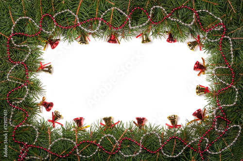 Christmas frame made of fir branches decorated with beads and bells isolated on white background