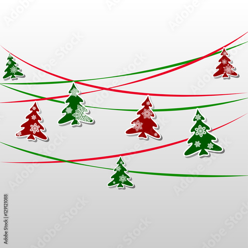 garland of green and red firs decorated with snowflakes photo