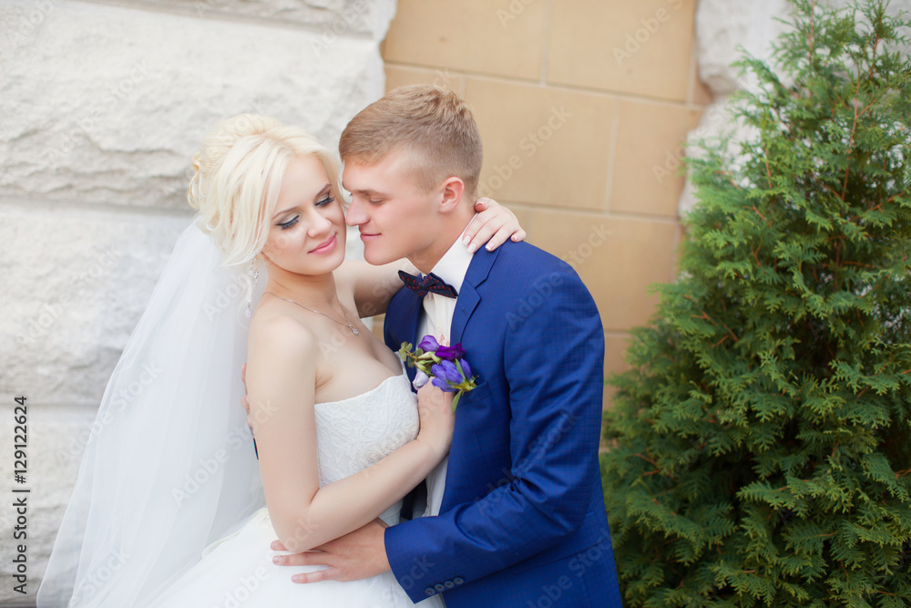 Fototapeta premium The groom gently hug the bride's shoulders