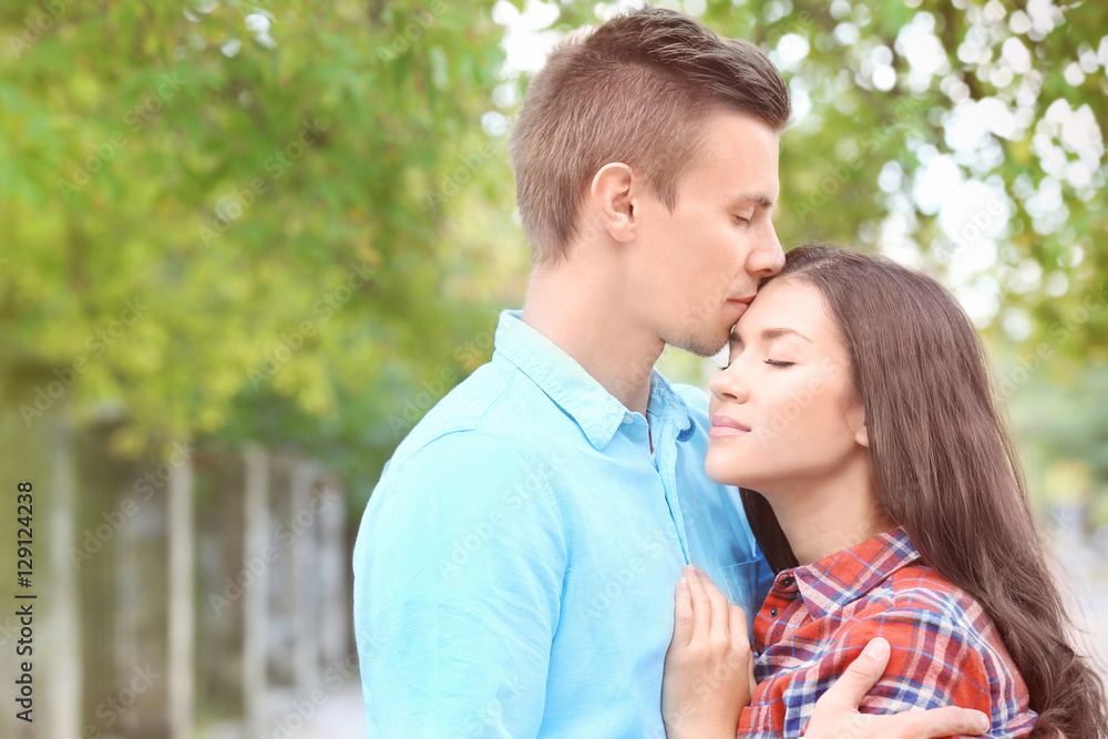 Portrait of beautiful young couple outdoors on blurred background Portrait of beautiful young couple outdoors on blurred background