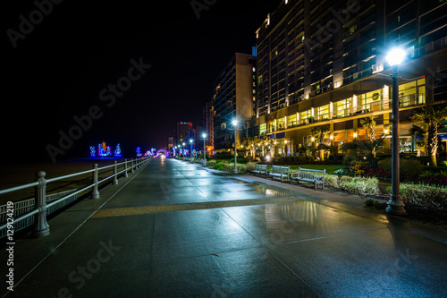 The boardwalk and highrise hotels at night in Virginia Beach, Vi