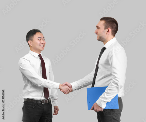 Handsome men shaking hands ...