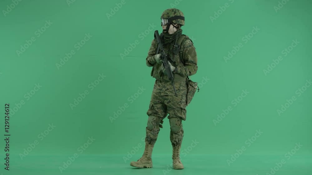 Soldier standing and looking around at green screen Soldier standing and looking around at green screen