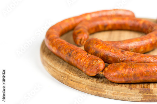Raw homemade domestic sausage on the wooden board. Isolated over