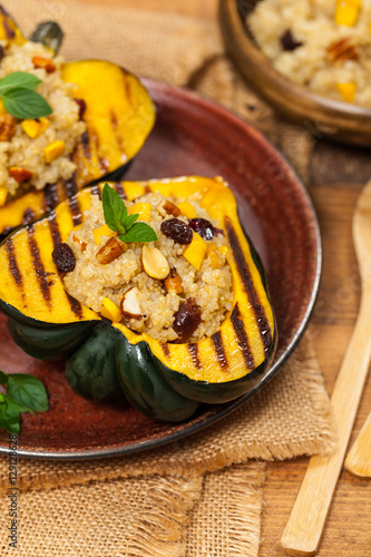 Roasted Pumpkin Stuffed with Quinoa, Nuts and Dried Fruit. Selective focus.
