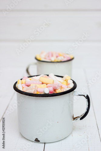 Two cups of hot cocoa with color marshmallow