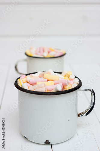 Two cups of hot cocoa with color marshmallow