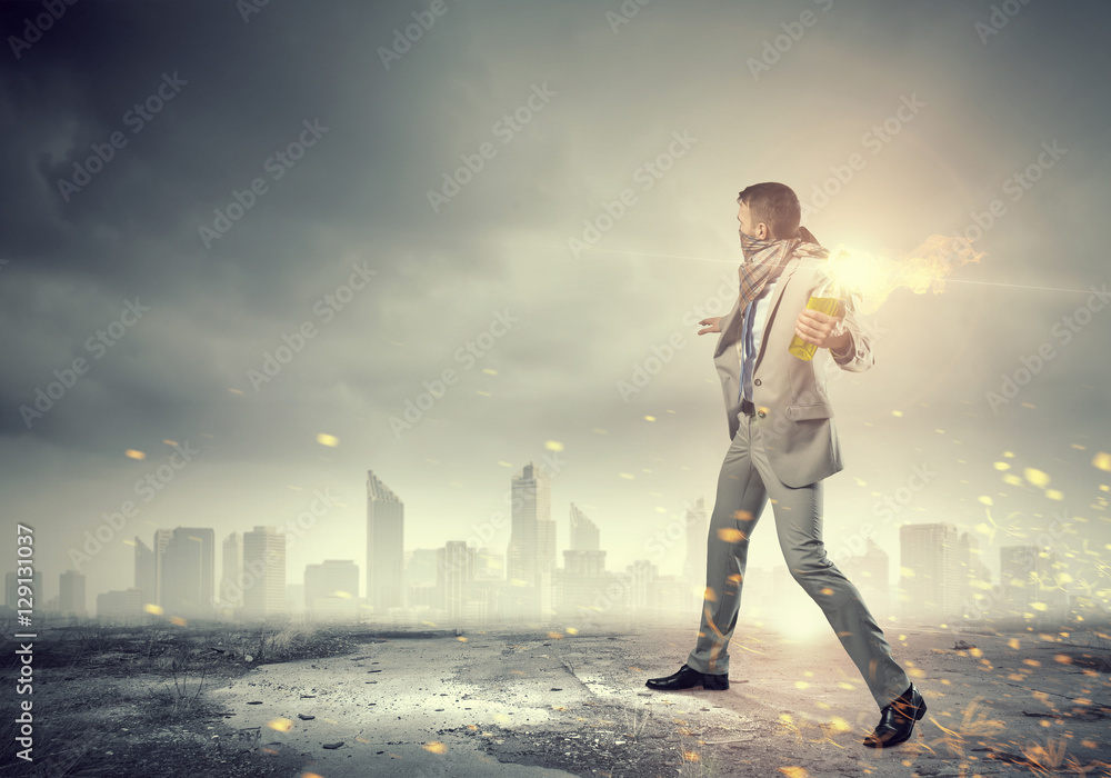 Businessman throwing petrol bomb . Mixed media Businessman throwing petrol bomb . Mixed media