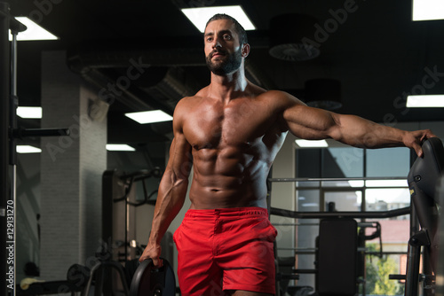 Fit Man Holding Weights In Hand