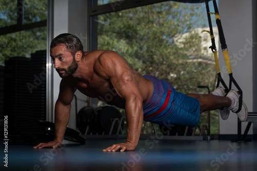 Man Exercising Push Ups With Trx Fitness Straps