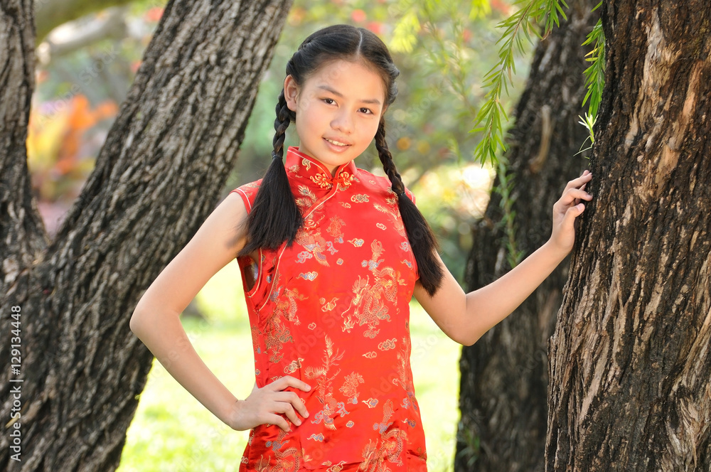 12 years old Asian girl in red Chinese new year Dress post profi