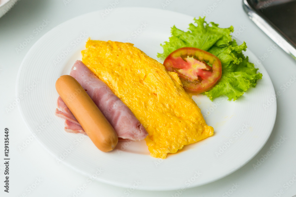 Breakfast of omelette with tomatoes and vegetable on dish. Breakfast of omelette with tomatoes and vegetable on dish.