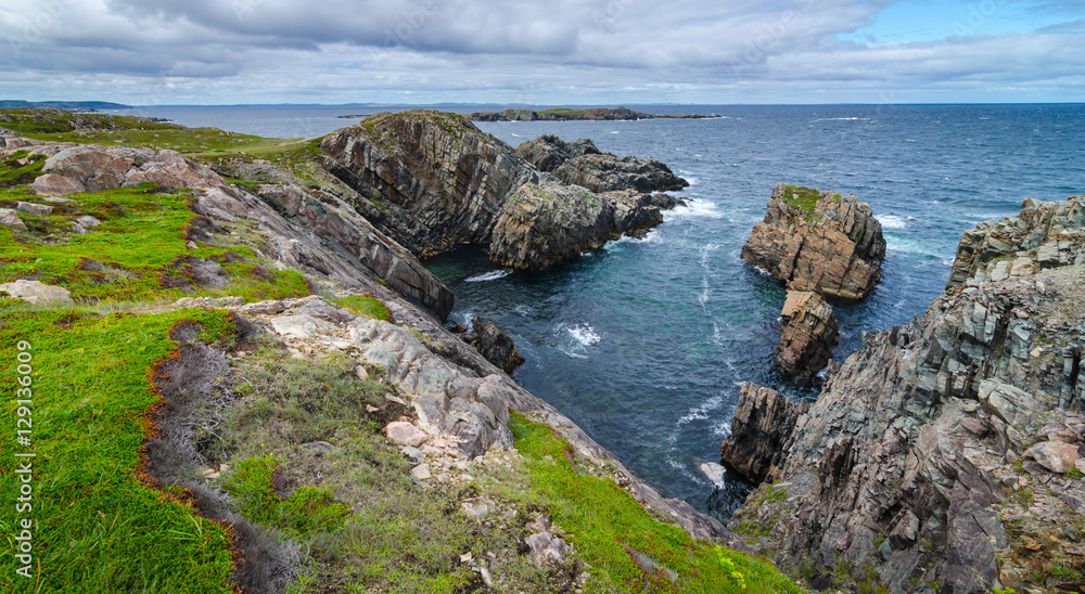 Cape Bonavista featuring coastal slabs of stone boulders and rocks that show their layers of formation over millions of years. Rocky boulder shoreline in Newfoundland, Canada. Cape Bonavista featuring coastal slabs of stone boulders and rocks that show their layers of formation over millions of years. Rocky boulder shoreline in Newfoundland, Canada.
