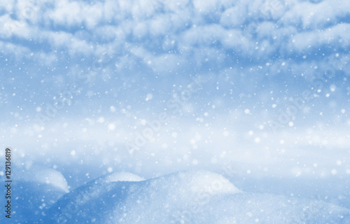 Winter background. Winter landscape with snowdrifts and blue sky with clouds