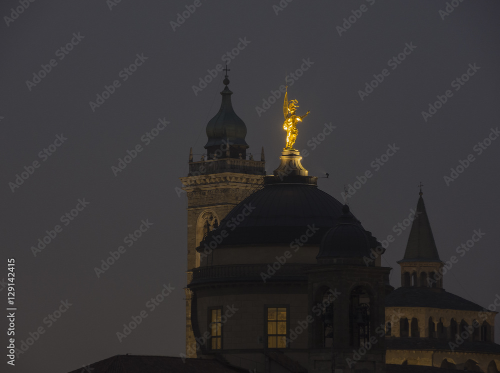 Bergamo - Old city (Citta Alta). One of the beautiful city in Italy. Lombardia. Evening landscape. The clock tower called Il Campanone (the big bell) and towers Bergamo - Old city (Citta Alta). One of the beautiful city in Italy. Lombardia. Evening landscape. The clock tower called Il Campanone (the big bell) and towers