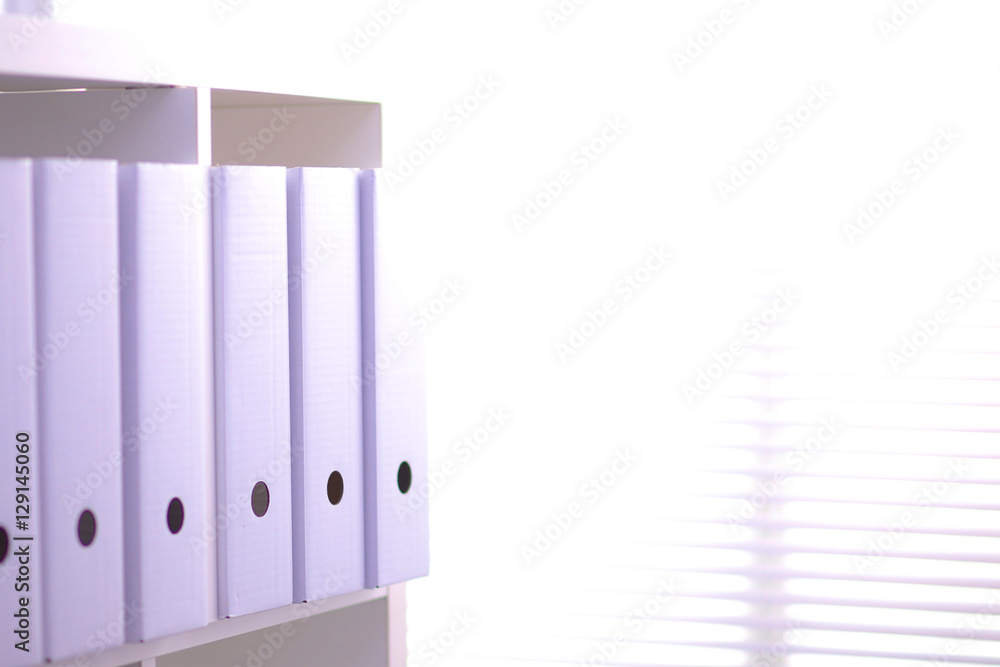 File folders, standing on shelves in the background File folders, standing on shelves in the background