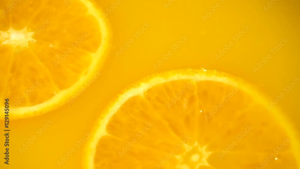 Sliced orange falling into orange juice Sliced orange falling into orange juice