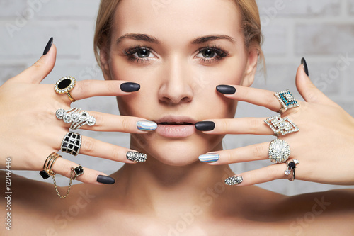 beauty face.woman's hands with jewelry rings.close-up beauty and fashion girl,manicure photo