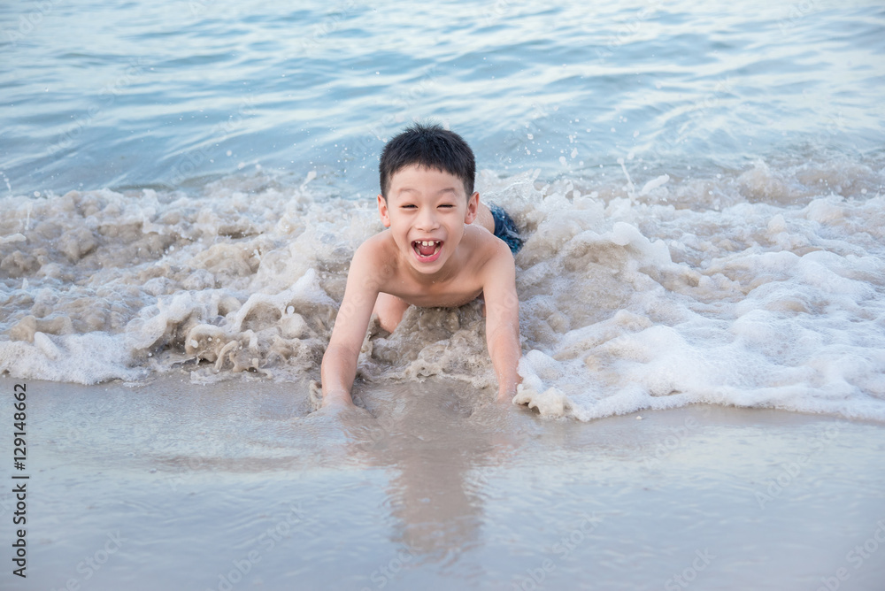 Young asian boy playing on the beach Young asian boy playing on the beach