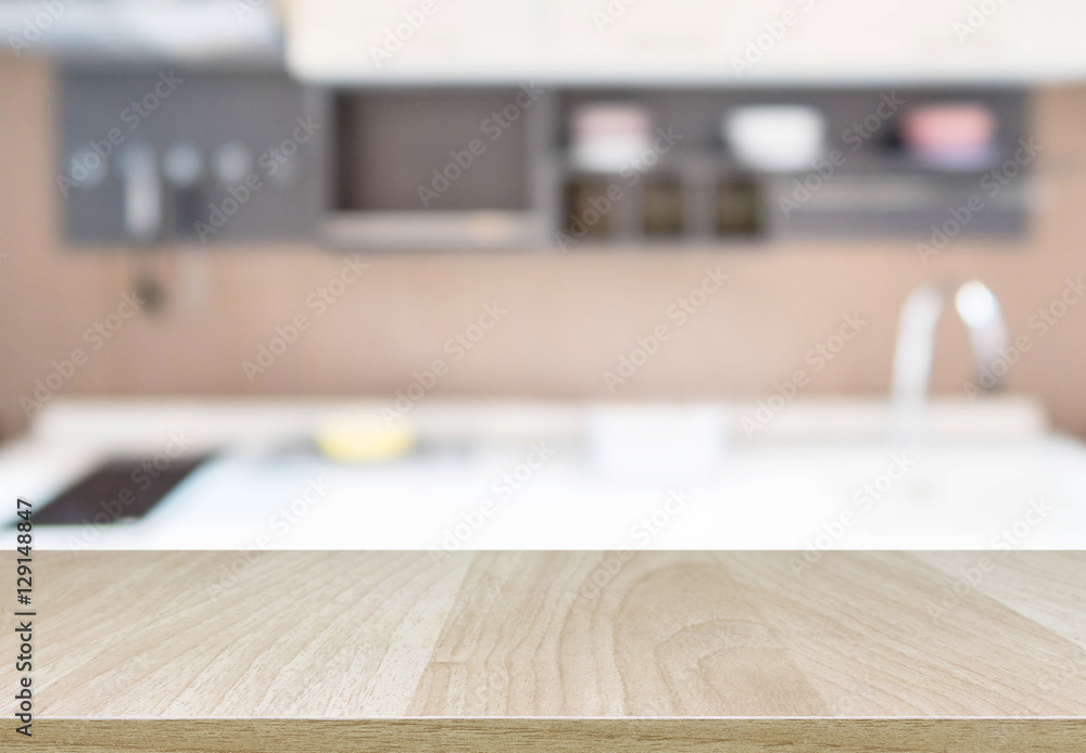 Wood table top and blurred kitchen interior background with vintage filter - can used for display or montage your products.