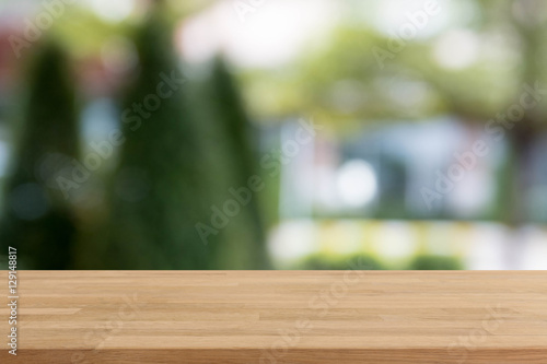Wood table top and blurred garden and tree background - can used for display or montage your products.